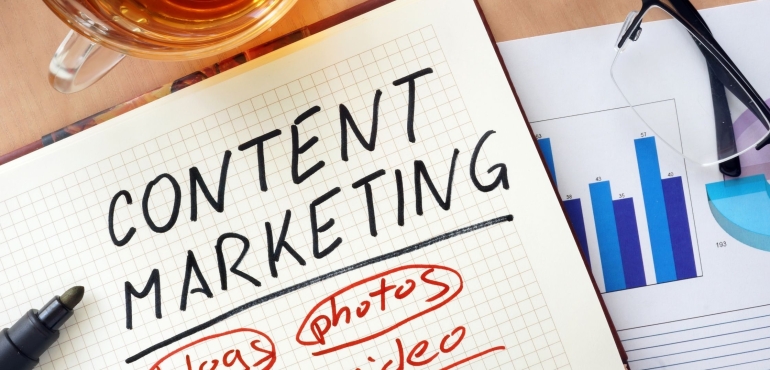 Content marketing 2023: in primo piano un quaderno con scritto a pennarello content marketing